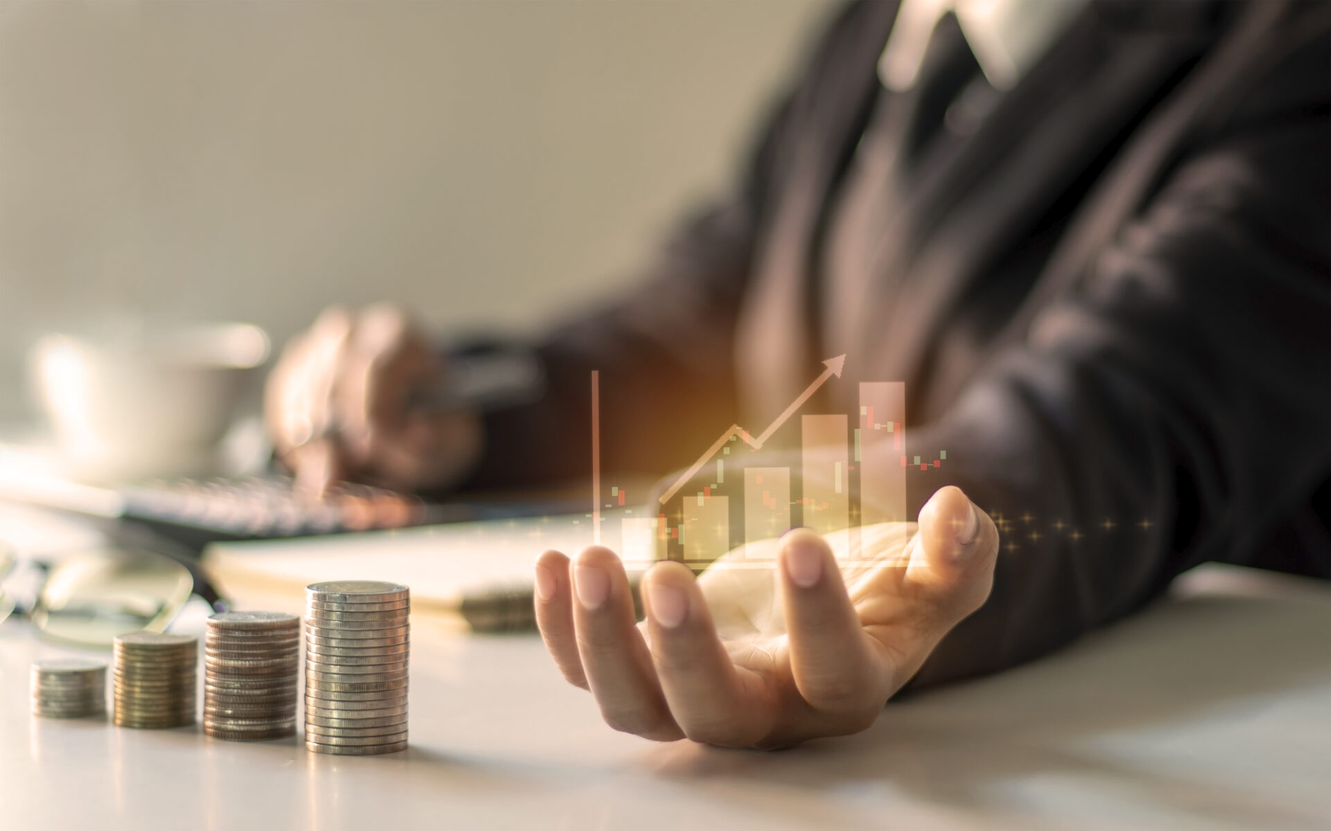 Financial growth graph with hand and coins representing wealth management